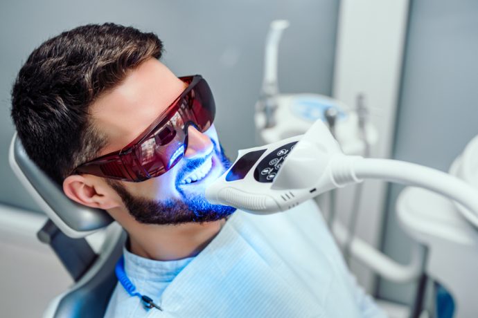 Patient receiving professional teeth whitening treatment