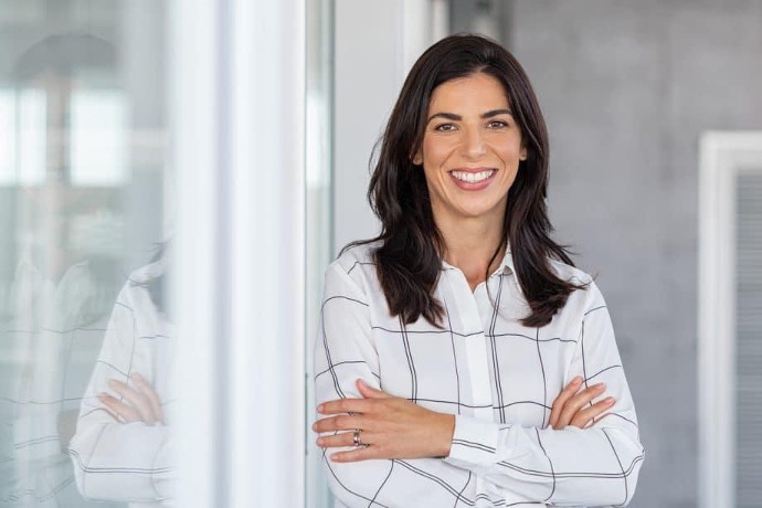 Female dentist smiling with folded arms